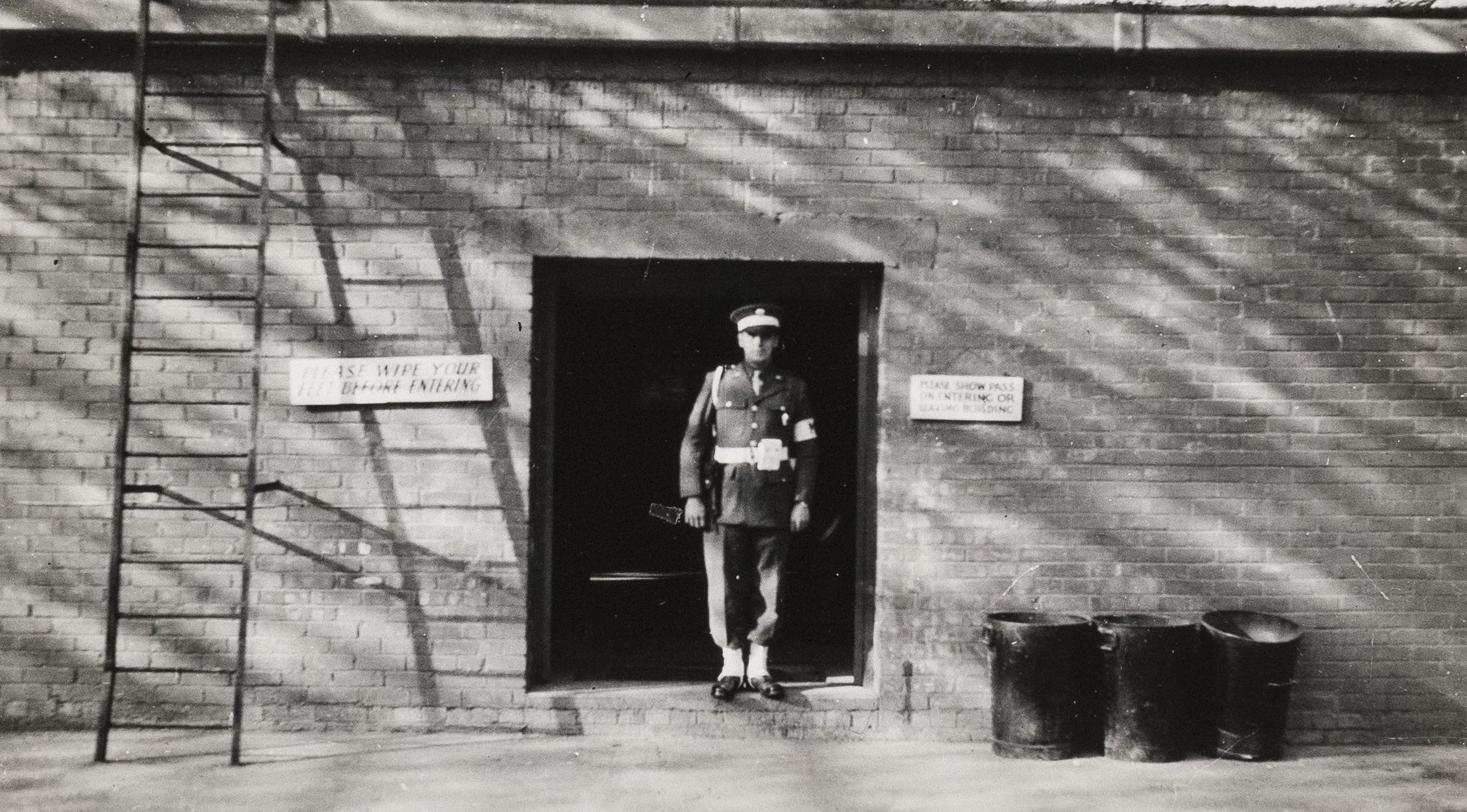 Officer standing outside a brick building in Camp Griffiss