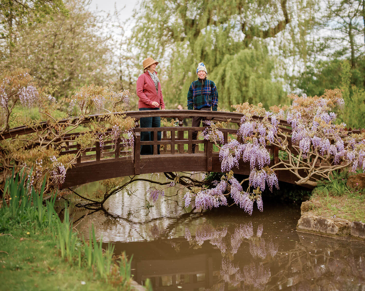 Two people on a picturesque wooden bridge in The Regent's Park