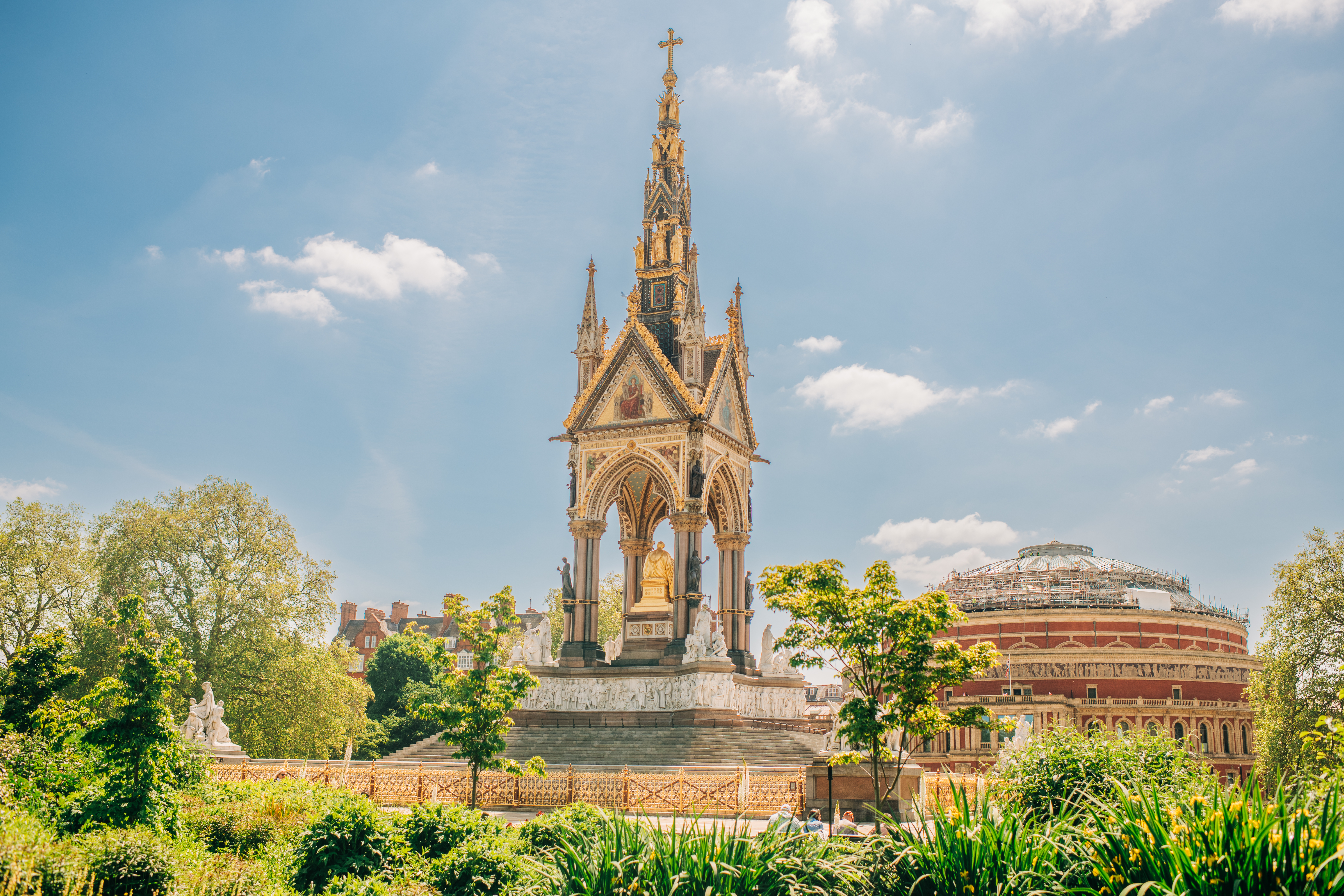 Image of a golden memorial amidst a lush green park