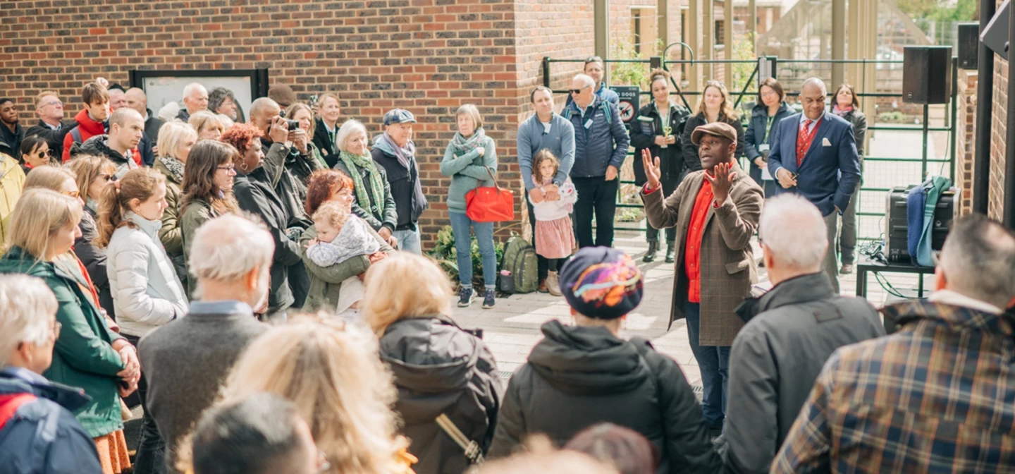 A group of people surrounding actor, Paterson Joseph, as he speaks about Ignatius Sancho