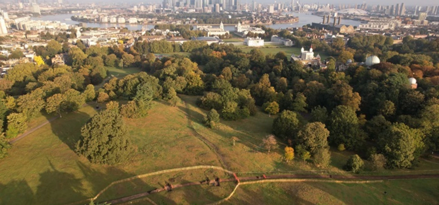 An aerial view of Greenwich Park and the Saxon Barrow Cemeteries with Canary Wharf in the distance