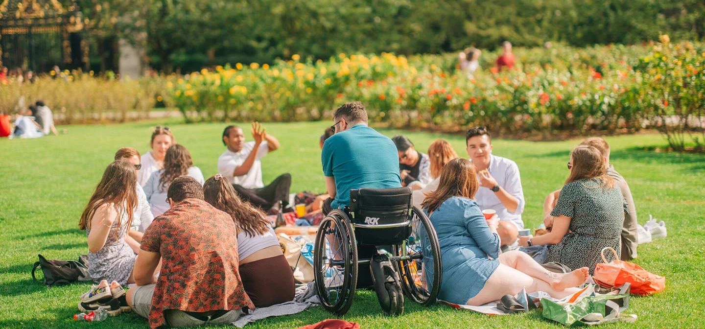 A group of young people sitting on the grass