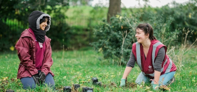 Two volunteers planting