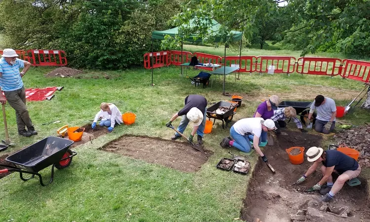 The archaeology dig at the Magnetic Observatory with volunteers digging the site.