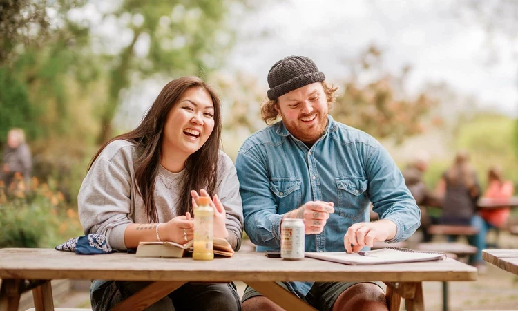 A man and woman at a picnic bench