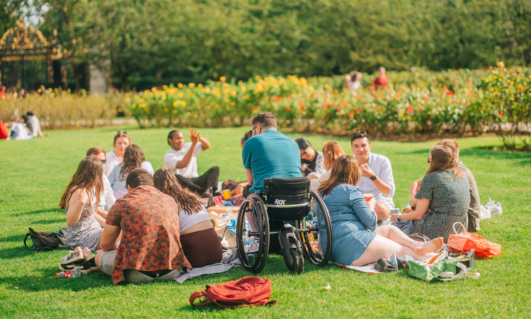 A group of young people sitting on the grass