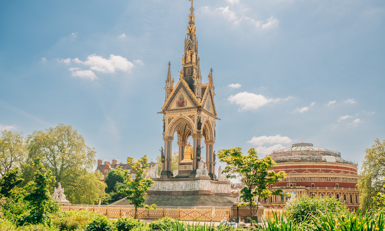 Image of a golden memorial amidst a lush green park