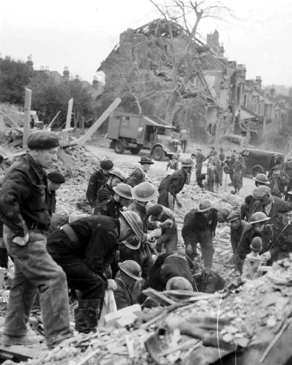 A bombed London street with rescue workers