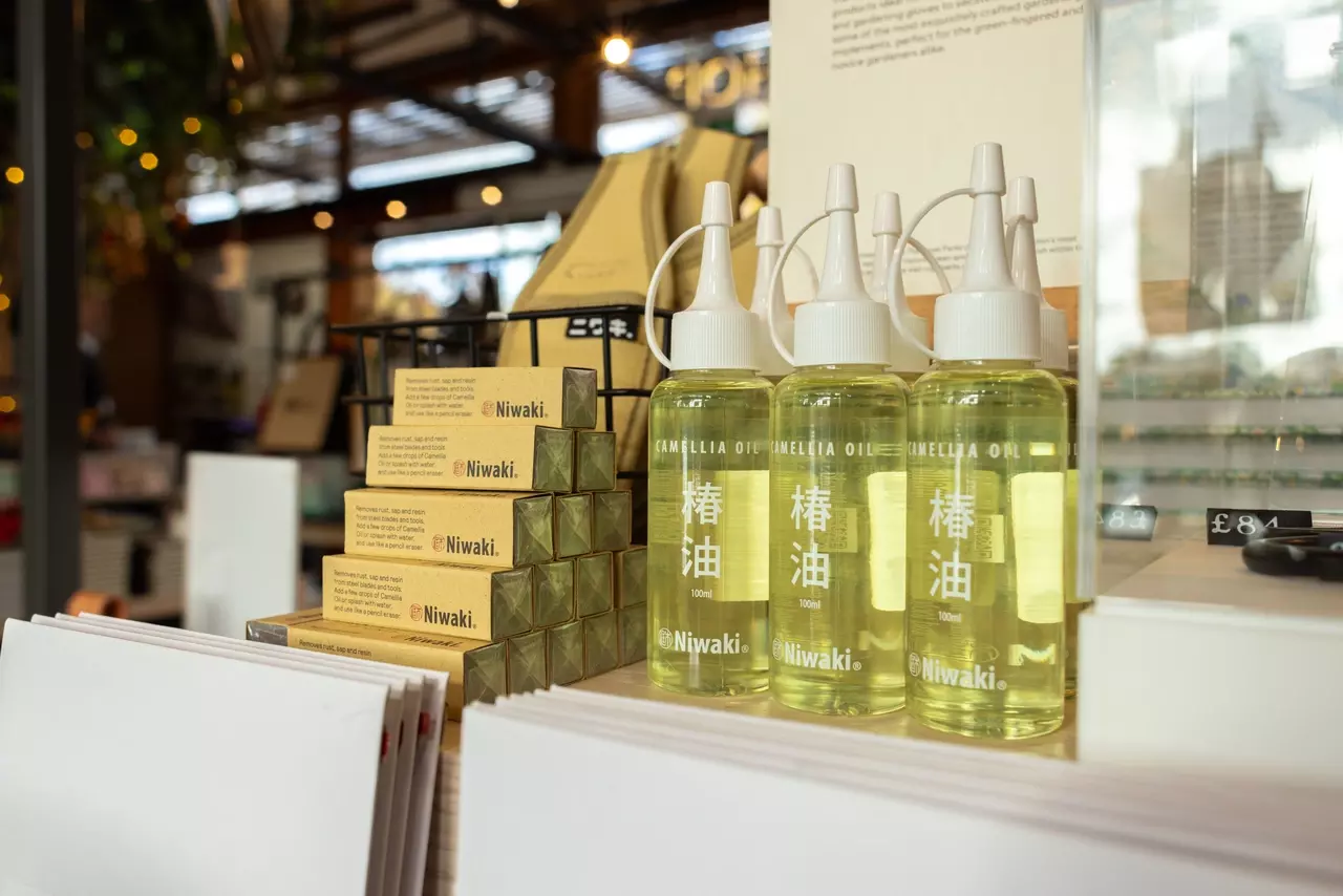 Stacked bottles of Camellia Oil on display in the TRP Shop 