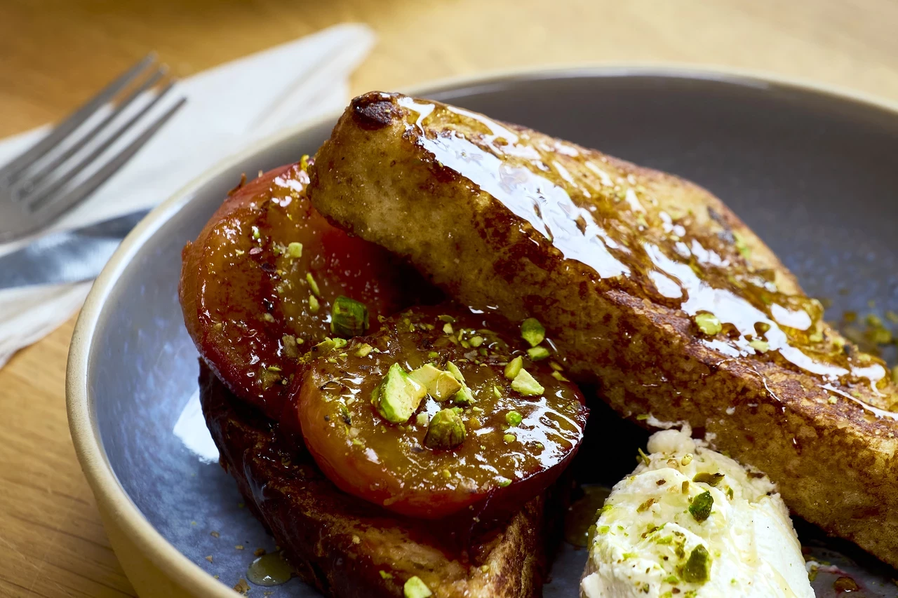 Close-up image of french toast on a grey plate.