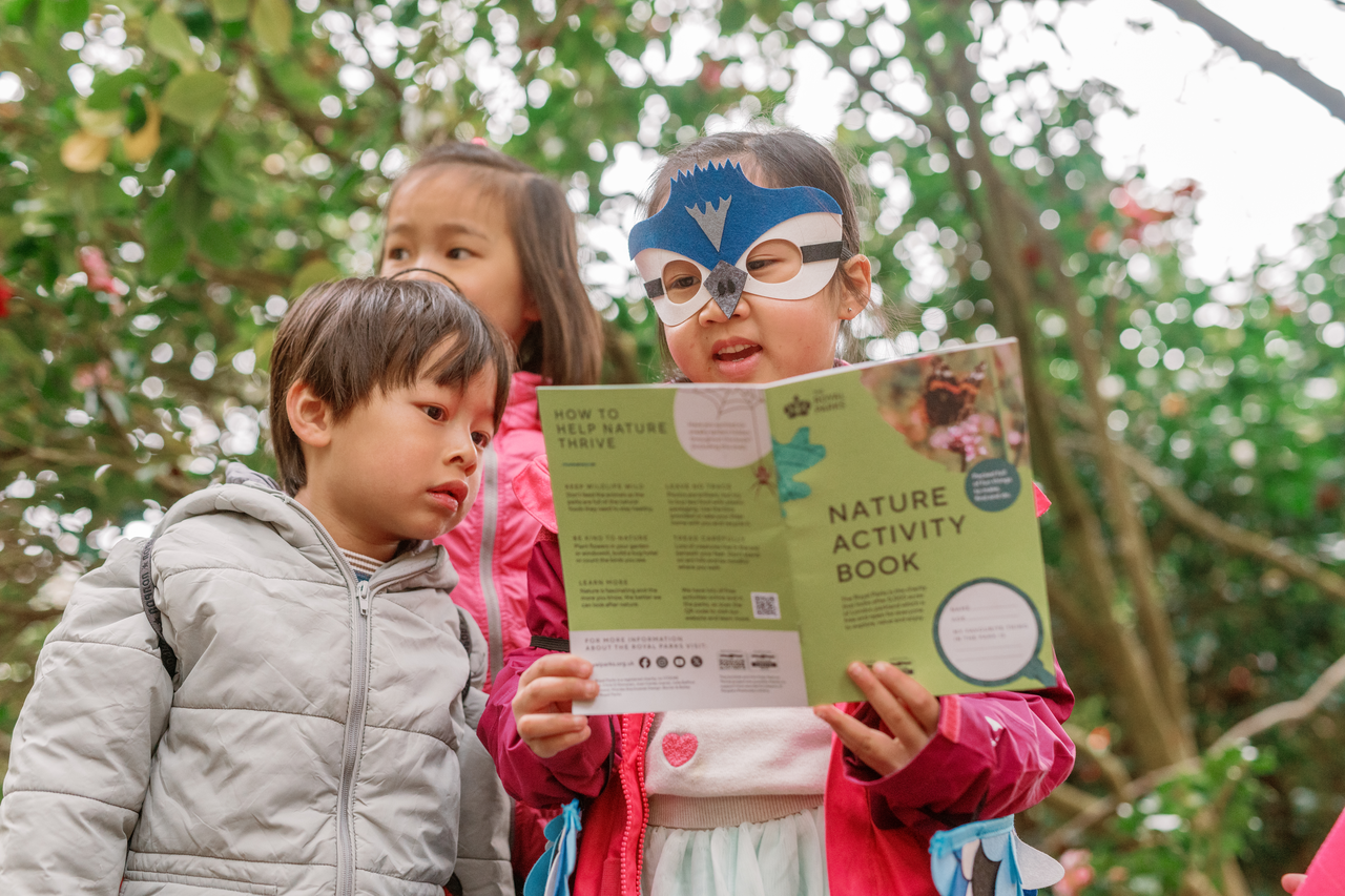 Children looking at a Nature Activity Book